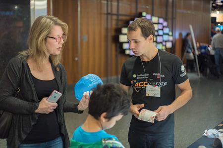 Collaborator Matt Jeffs talks with a visitor at the ACCelerate Festival